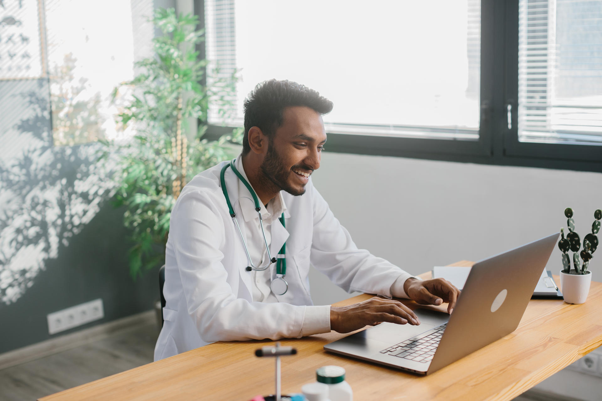 an-asian-doctor-uses-a-laptop-to-conduct-an-online-2025-02-22-16-10-31-utc.jpg